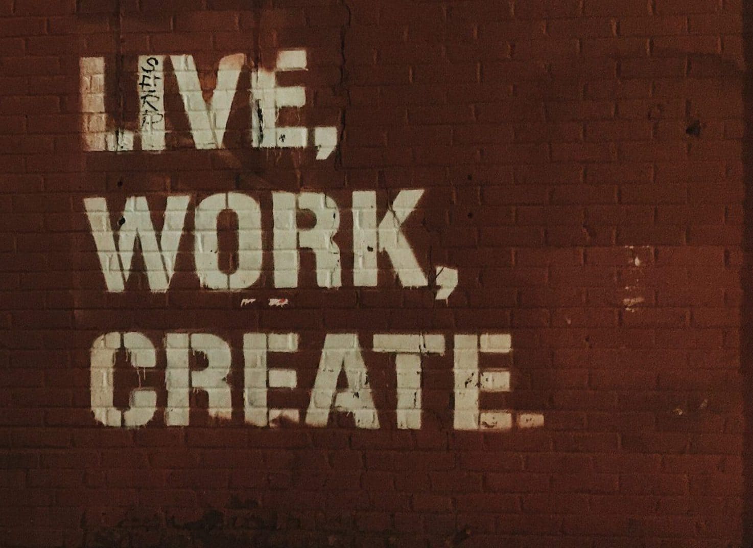 web design services red brick wall with live, work, create. quote
